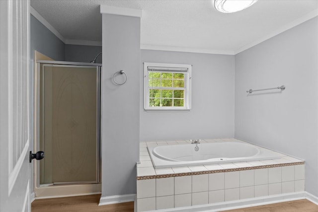 724 Shelly Ln, Rossville, GA 30741 - bathroom featuring a shower stall, a garden tub, wood finished floors, crown molding, and a textured ceiling