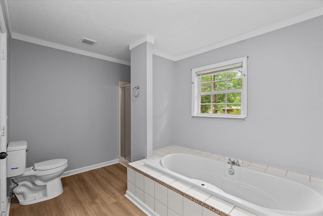 724 Shelly Ln, Rossville, GA 30741 - full bathroom featuring a garden tub, wood finished floors, a stall shower, crown molding, and a textured ceiling