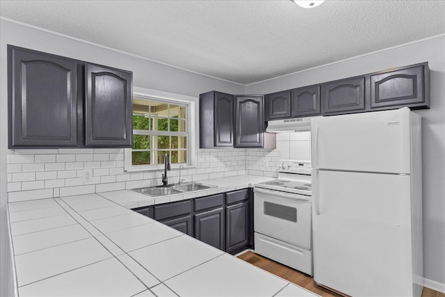 724 Shelly Ln, Rossville, GA 30741 - kitchen featuring white appliances, tile counters, under cabinet range hood, a textured ceiling, and backsplash