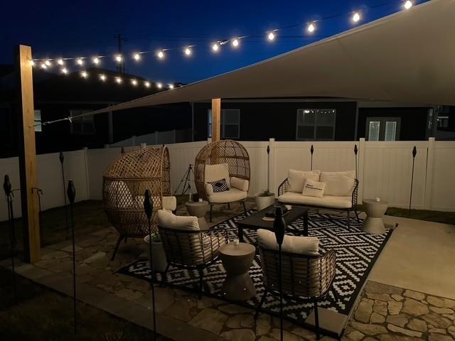 1006 Pepper Stone Dr, Lebanon, TN 37087 - patio at twilight featuring an outdoor hangout area, a fenced backyard, and a patio