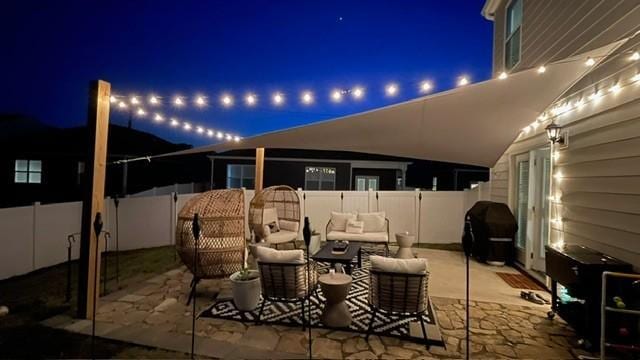 1006 Pepper Stone Dr, Lebanon, TN 37087 - patio at night featuring an outdoor hangout area, a grill, and a patio