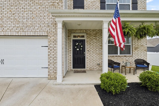 1006 Pepper Stone Dr, Lebanon, TN 37087 - view of exterior entry featuring brick siding, a porch, an attached garage, and driveway