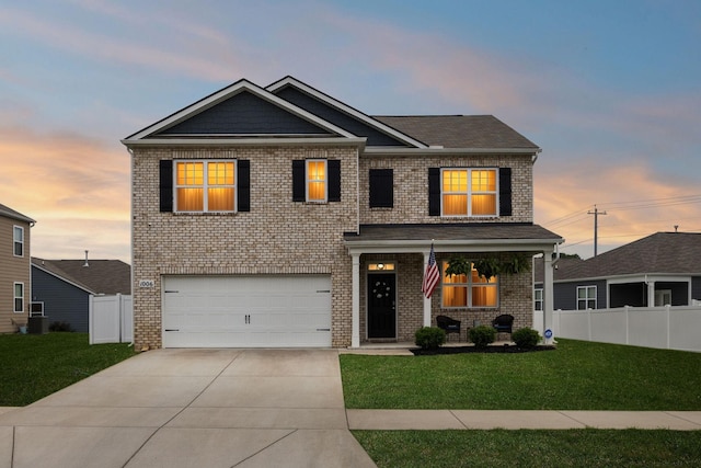1006 Pepper Stone Dr, Lebanon, TN 37087 - view of front facade featuring a garage, concrete driveway, brick siding, and covered porch