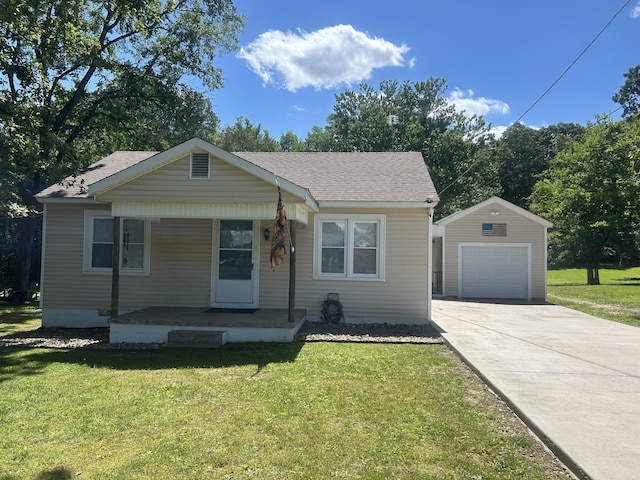 273 Washington Ave, Camden, TN 38320 - bungalow featuring a porch, an outbuilding, concrete driveway, and a front yard