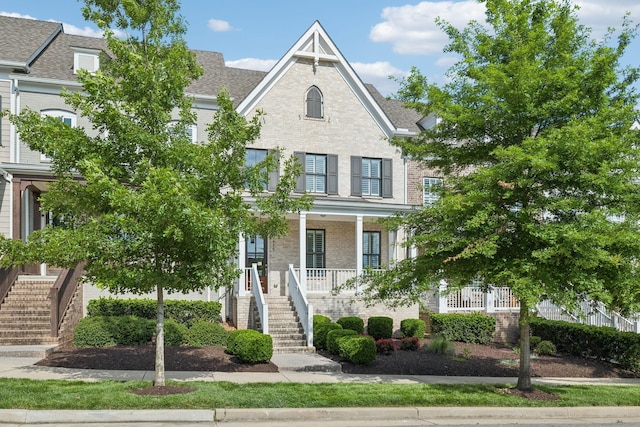 479 Courfield Dr, Franklin, TN 37064 - view of property with stairway, a porch, brick siding, and roof with shingles