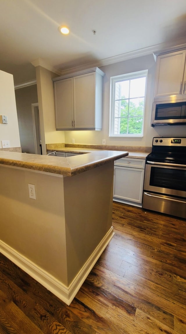 4316 Summercrest Blvd Unit 519, Antioch, TN 37013 - kitchen featuring stainless steel appliances, ornamental molding, dark wood-style floors, recessed lighting, and light countertops