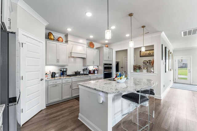 134 Wynfield Blvd, Mount Juliet, TN 37122 - kitchen with appliances with stainless steel finishes, ornamental molding, premium range hood, tasteful backsplash, and dark wood-style flooring