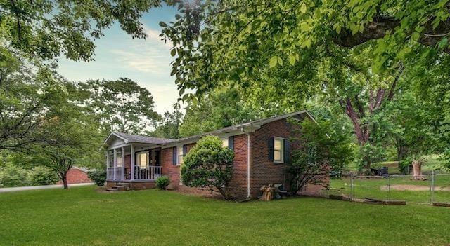 3071 Bayshore Dr, Cookeville, TN 38506 - view of front of home featuring a front yard, brick siding, and a porch
