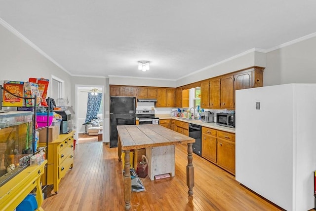 3071 Bayshore Dr, Cookeville, TN 38506 - kitchen featuring black appliances, a sink, light wood-type flooring, crown molding, and tile counters