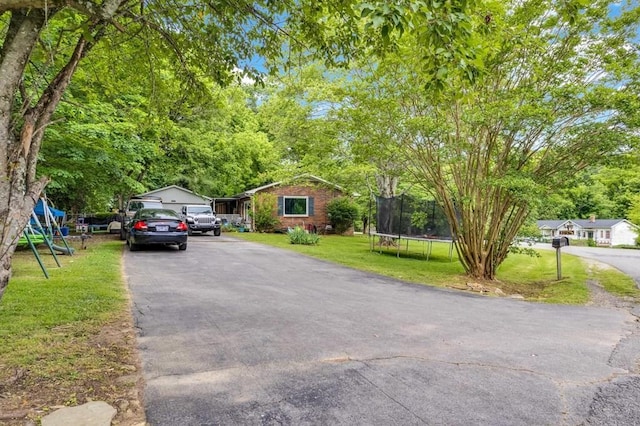 3071 Bayshore Dr, Cookeville, TN 38506 - view of front of house featuring a trampoline, a front lawn, and driveway