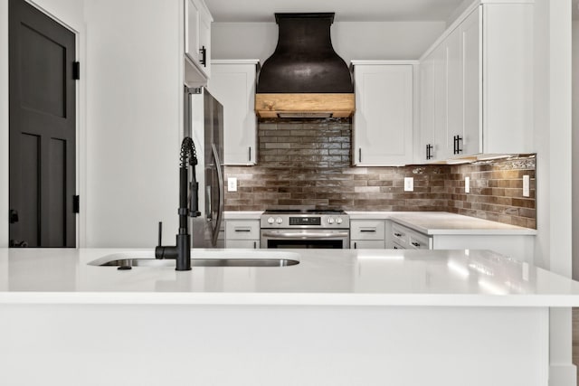 827 Oconner St, Smithville, TN 37166 - kitchen featuring stainless steel appliances, custom range hood, light countertops, white cabinets, and tasteful backsplash