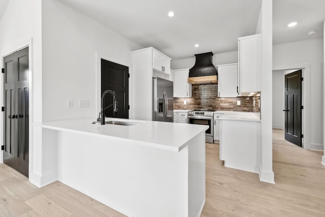 827 Oconner St, Smithville, TN 37166 - kitchen featuring appliances with stainless steel finishes, a sink, premium range hood, tasteful backsplash, and light wood finished floors