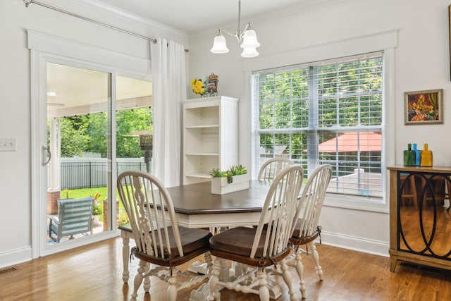 5405 Cliffstone Dr, Smyrna, TN 37167 - dining space featuring baseboards, ornamental molding, wood finished floors, and a chandelier