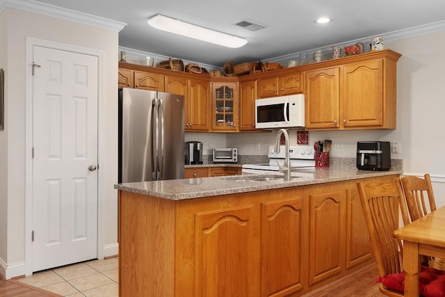 72 Anchor Dr, Rossville, GA 30741 - kitchen with white appliances, a peninsula, a sink, crown molding, and brown cabinetry