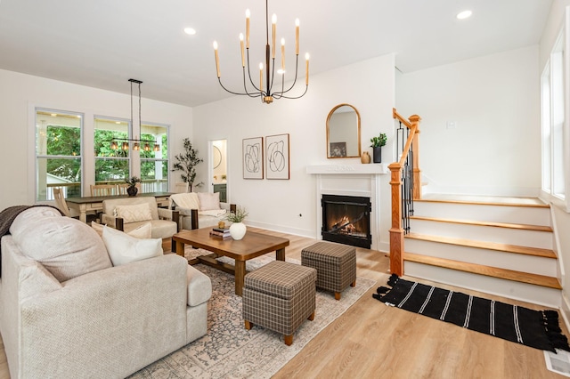 311 N 9th St, Nashville, TN 37206 - living area featuring wood finished floors, recessed lighting, a chandelier, stairs, and a glass covered fireplace