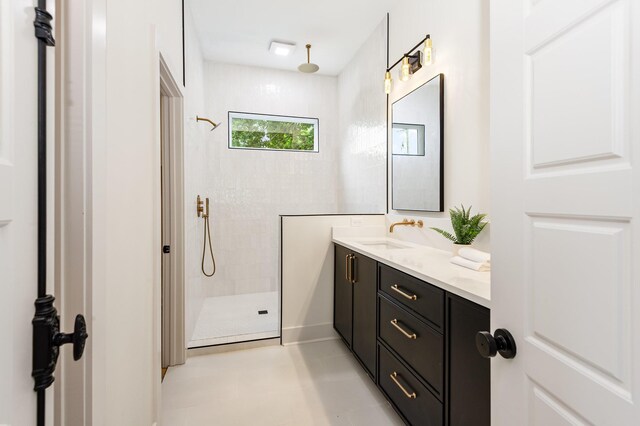311 N 9th St, Nashville, TN 37206 - bathroom featuring double vanity, a walk in shower, and baseboards