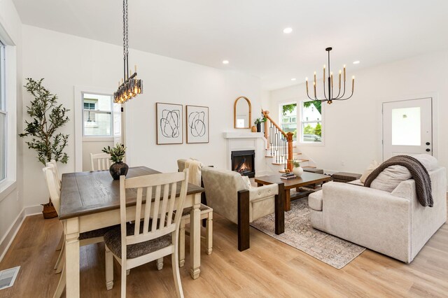 311 N 9th St, Nashville, TN 37206 - living area with a chandelier, light wood-type flooring, recessed lighting, a warm lit fireplace, and stairs
