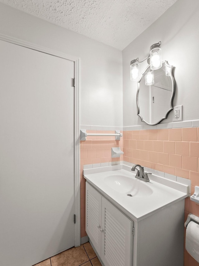 806 Pleasant View Dr, Winchester, TN 37398 - bathroom with vanity, tile patterned flooring, a textured ceiling, tile walls, and a wainscoted wall
