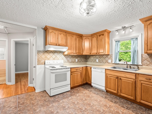 806 Pleasant View Dr, Winchester, TN 37398 - kitchen featuring white appliances, a sink, under cabinet range hood, light countertops, and decorative backsplash