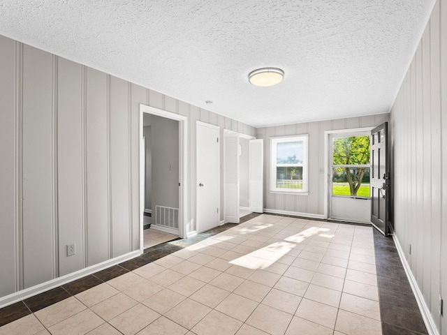 806 Pleasant View Dr, Winchester, TN 37398 - empty room with a decorative wall, tile patterned flooring, and a textured ceiling