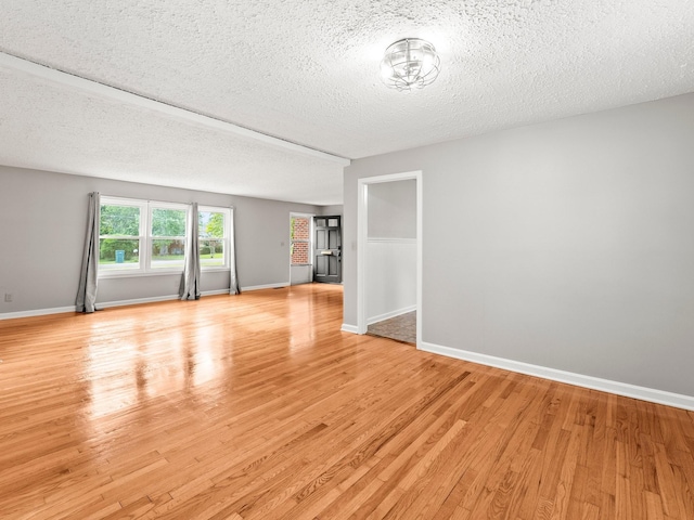 806 Pleasant View Dr, Winchester, TN 37398 - empty room featuring light wood-type flooring, a textured ceiling, and baseboards