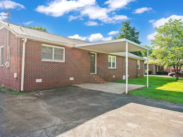806 Pleasant View Dr, Winchester, TN 37398 - view of property exterior with entry steps, crawl space, a lawn, brick siding, and metal roof