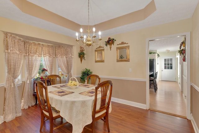 108 Dalewood Cir, Chickamauga, GA 30707 - dining area with wood finished floors, baseboards, a chandelier, and a tray ceiling