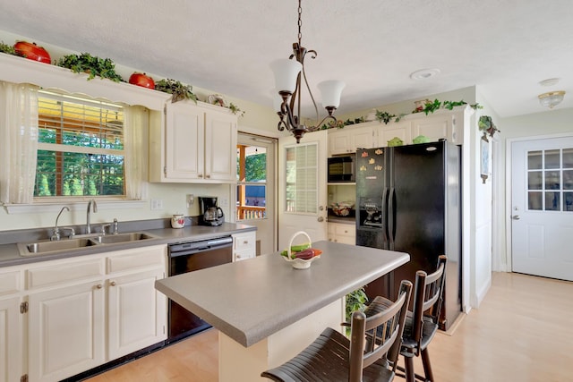 108 Dalewood Cir, Chickamauga, GA 30707 - kitchen with black appliances, a sink, a kitchen bar, and light wood finished floors