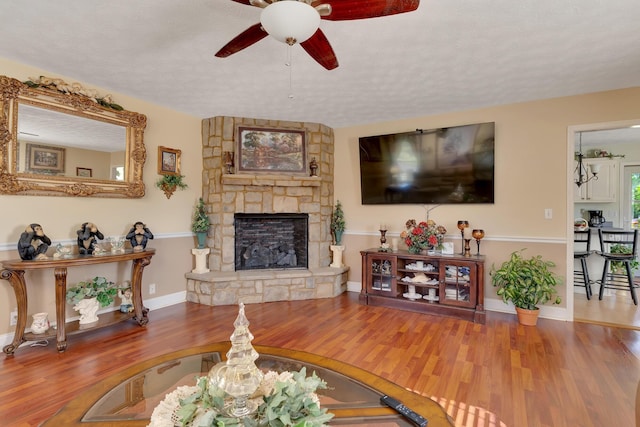 108 Dalewood Cir, Chickamauga, GA 30707 - living room with a ceiling fan, wood finished floors, a stone fireplace, and baseboards