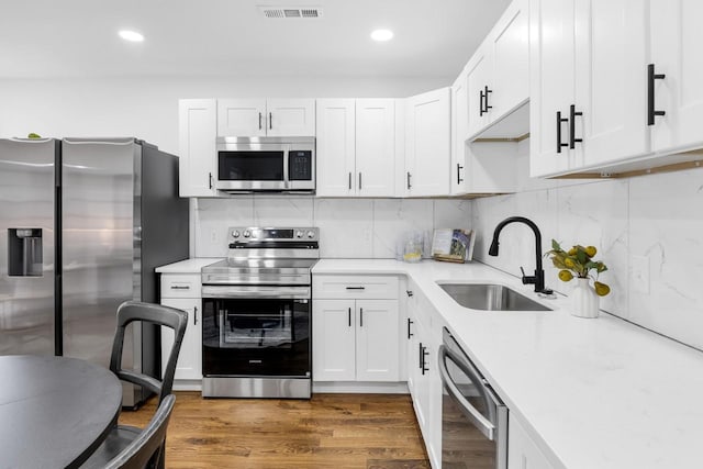 1104 Howell St, Hopkinsville, KY 42240 - kitchen featuring stainless steel appliances, a sink, light countertops, white cabinets, and recessed lighting