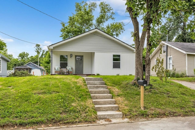 1104 Howell St, Hopkinsville, KY 42240 - view of front of property featuring a front lawn, covered porch, and stairs