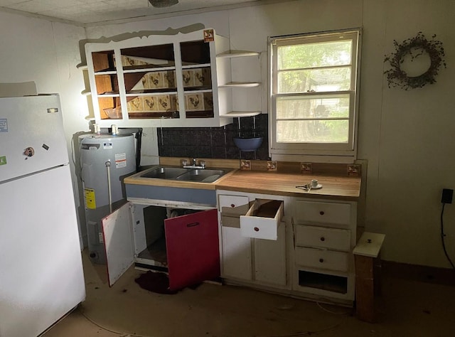 3442 E Cross St, Rives, TN 38253 - kitchen featuring freestanding refrigerator, a sink, electric water heater, and open shelves