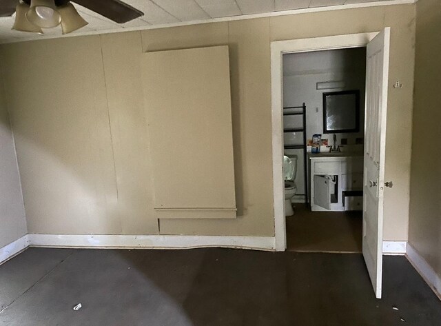 3442 E Cross St, Rives, TN 38253 - unfurnished room with baseboards, ceiling fan, and concrete floors