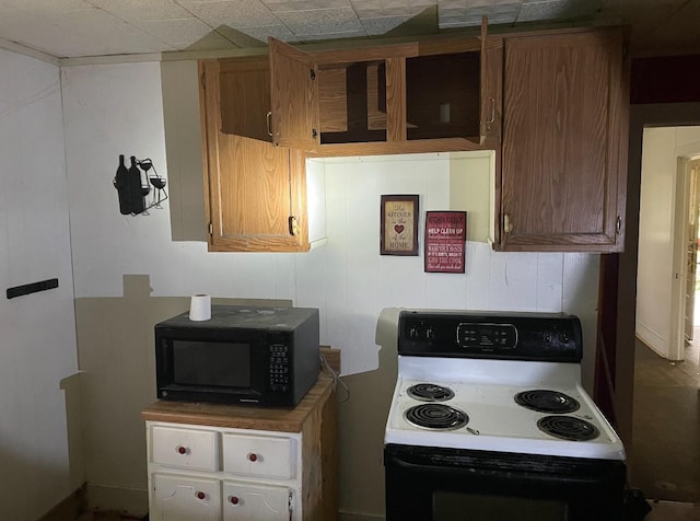 3442 E Cross St, Rives, TN 38253 - kitchen featuring range with electric cooktop, black microwave, and brown cabinets