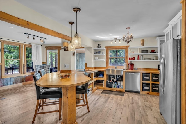 1353 Chapmansboro Rd, Chapmansboro, TN 37035 - dining room featuring light wood-style flooring, healthy amount of natural light, and a chandelier