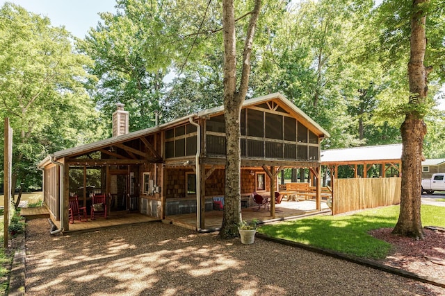 1353 Chapmansboro Rd, Chapmansboro, TN 37035 - rear view of house with a chimney, a sunroom, and a patio area