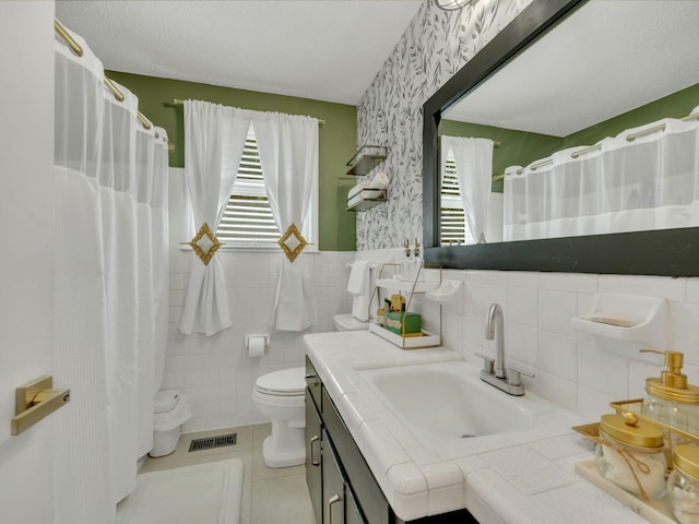 503 Ginkgo Dr, Clarksville, TN 37042 - bathroom featuring toilet, tile patterned floors, vanity, wallpapered walls, and wainscoting