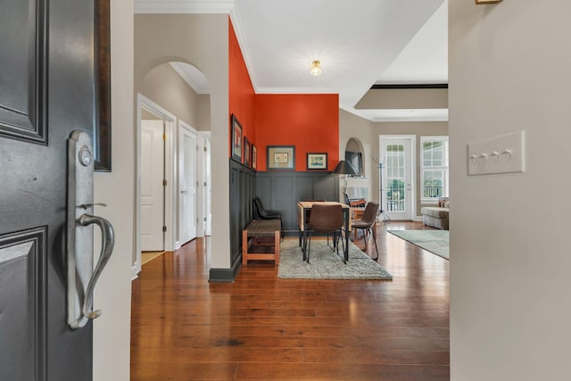 307 Seven Springs Way Unit 402, Brentwood, TN 37027 - foyer with arched walkways, hardwood / wood-style floors, ornamental molding, and a decorative wall