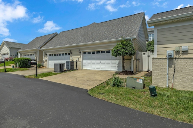 1552 Charleston Blvd, Murfreesboro, TN 37130 - view of property exterior with driveway, central AC, a garage, and roof with shingles