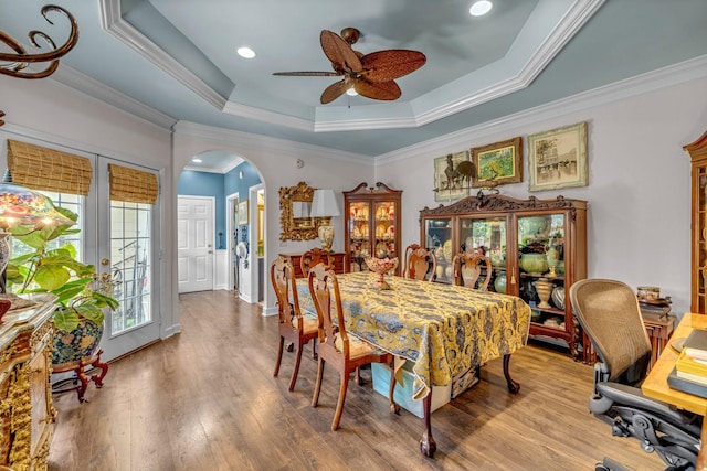1552 Charleston Blvd, Murfreesboro, TN 37130 - dining room with a tray ceiling, arched walkways, ceiling fan, crown molding, and wood finished floors