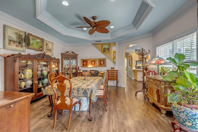 1552 Charleston Blvd, Murfreesboro, TN 37130 - dining space with arched walkways, a raised ceiling, a ceiling fan, wood finished floors, and ornamental molding