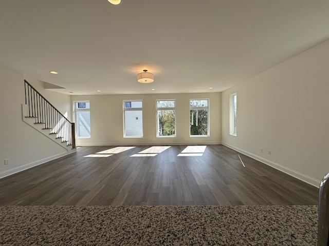 218 Myatt Dr Unit C, Madison, TN 37115 - unfurnished living room featuring baseboards, dark wood-type flooring, healthy amount of natural light, recessed lighting, and stairway