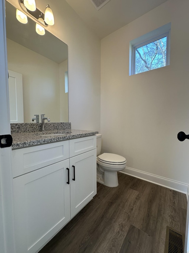 218 Myatt Dr Unit C, Madison, TN 37115 - half bath with wood finished floors, vanity, toilet, and baseboards