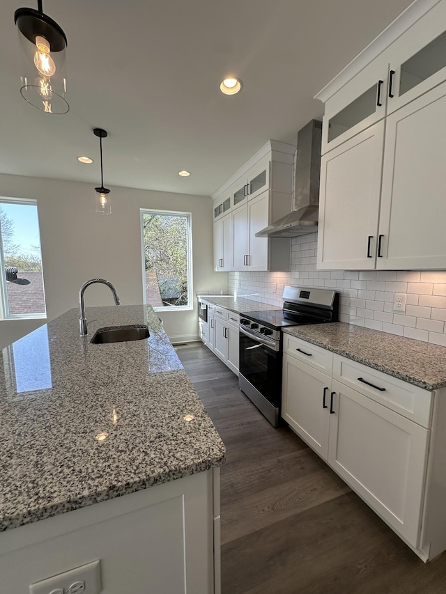 218 Myatt Dr Unit C, Madison, TN 37115 - kitchen featuring stainless steel range with electric stovetop, wall chimney range hood, a sink, white cabinetry, and recessed lighting