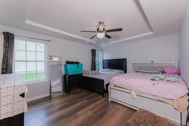 534 Mckean Dr, Smyrna, TN 37167 - bedroom with a raised ceiling, dark wood-style flooring, a textured ceiling, baseboards, and a ceiling fan