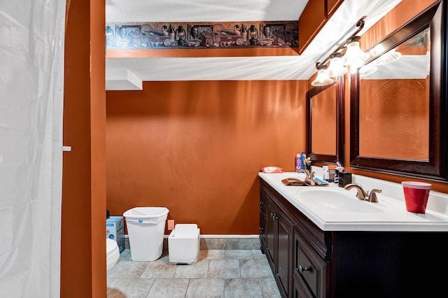 4028 Tomahawk Cir NW, Cleveland, TN 37312 - full bath featuring toilet, double vanity, baseboards, and stone finish floors