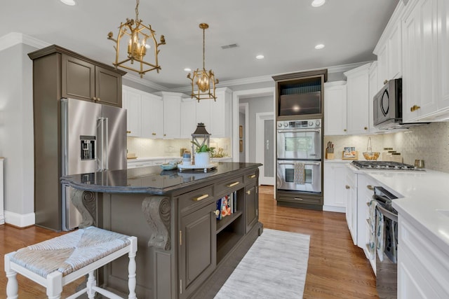 3630 Bear Creek Ln, Thompsons Station, TN 37179 - kitchen with stainless steel appliances, tasteful backsplash, recessed lighting, a kitchen island, and a chandelier