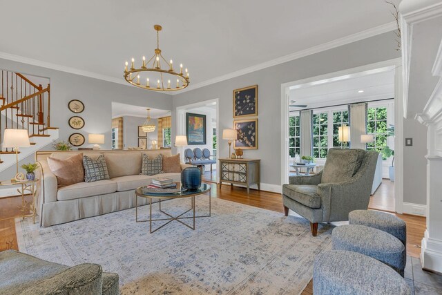 3630 Bear Creek Ln, Thompsons Station, TN 37179 - living room featuring stairs, wood finished floors, a chandelier, crown molding, and baseboards