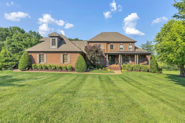 3630 Bear Creek Ln, Thompsons Station, TN 37179 - view of front of house featuring covered porch, a front yard, and brick siding
