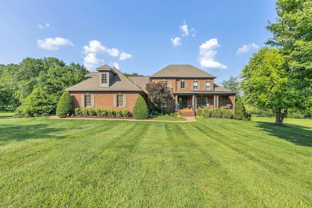 3630 Bear Creek Ln, Thompsons Station, TN 37179 - view of front facade with a front lawn, covered porch, and brick siding